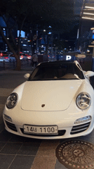 White Porsche 911 spotted parked on Seoul sidewalk
