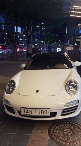 White Porsche 911 spotted parked on Seoul sidewalk
