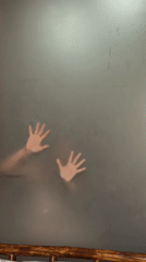 Mystery hands pressed against frosted glass in Wulingyuan