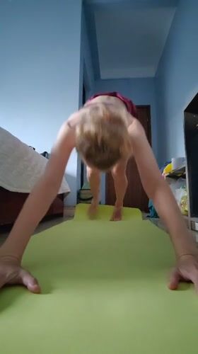 Woman practices morning yoga in bedroom in Vietnam
