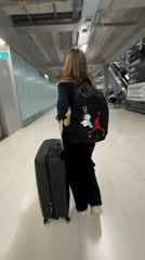 Moving through a Thai airport terminal with luggage in hand