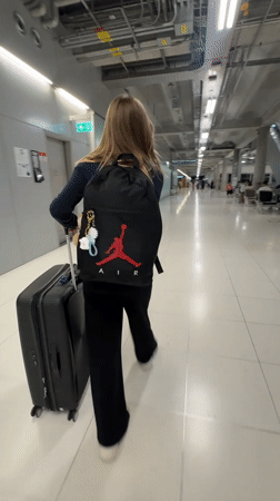 Moving through a Thai airport terminal with luggage in hand