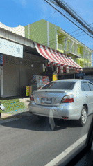 Street scene captured from moving car in Wichit, Thailand