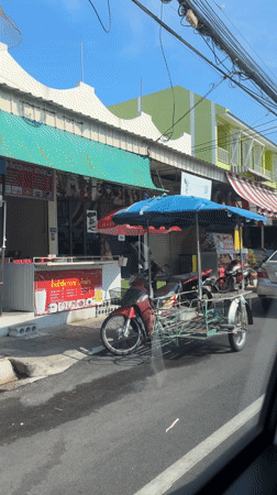 Street scene captured from moving car in Wichit, Thailand