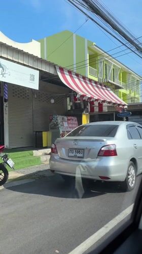 Street scene captured from moving car in Wichit, Thailand