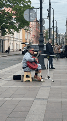 Street musician with bandaged legs performs in Saint Petersburg