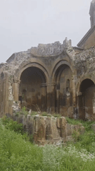 Visitor documents medieval Armenian monastery and surrounding village life
