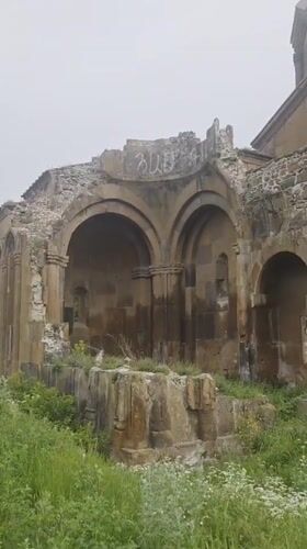 Visitor documents medieval Armenian monastery and surrounding village life