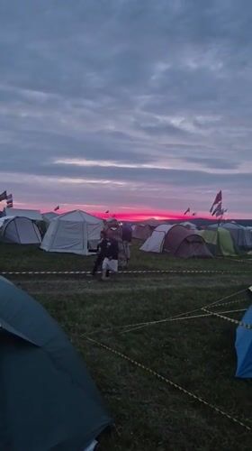 Evening campsite gathering in Lagunovo with costumes and lights