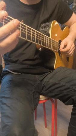 Street musician performs on guitar in Bobrovo, Russia