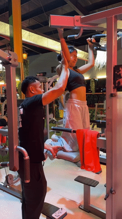 Gym workout session on a pull-up assist machine in Kuta