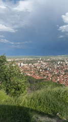 Aerial views capture unknown coastal city under cloudy skies
