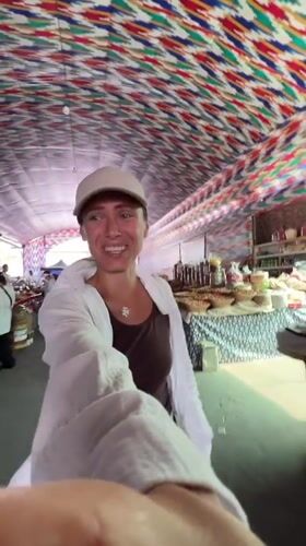 Tashkent market browse with a blue-domed landmark nearby