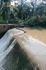 Water flows over concrete dam in Keudekrueng, Indonesia