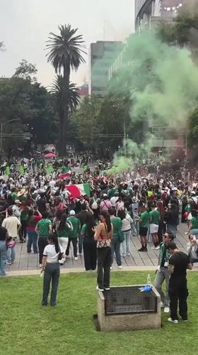 Crowds gather at Mexico City's Angel monument with flags