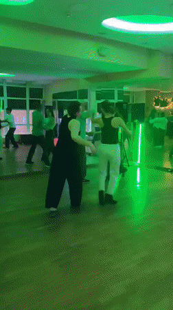Couples dance in colorful mirrored hall in Kyiv