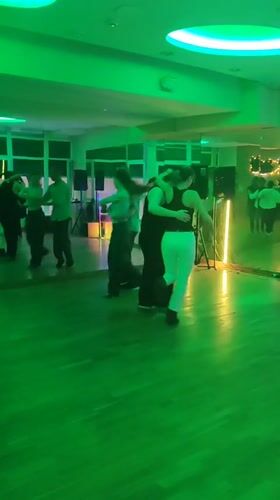 Couples dance in colorful mirrored hall in Kyiv