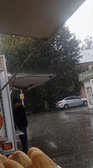 Street moments: a food cart exchange and a rainy sidewalk walk