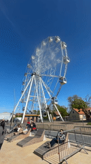 Crowds gather at seaside Ferris wheel during Russian running event