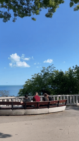 Visitors gather at Varna sea overlook on sunny afternoon