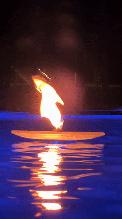 Illuminated fountains and floating torch at night in Krasnodar
