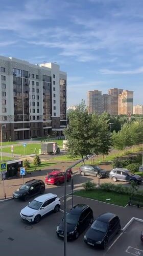 Kazan apartment complex and parking lot, summer afternoon