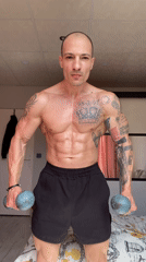 Man performs dumbbell workout on bed in Pleven bedroom