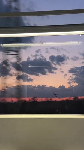 Train passenger captures sunset gradient through window in Bulgaria