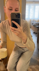 Woman takes mirror selfies with dog in Khimki apartment