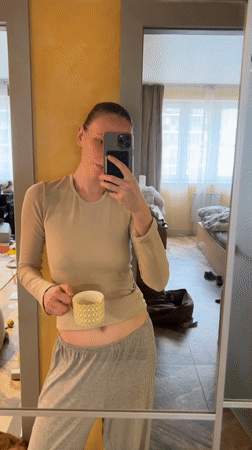 Woman takes mirror selfies with dog in Khimki apartment