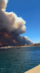 Wildfire smoke engulfs the sky above Palamós, Costa Brava