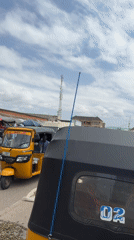 Jalingo street life: rickshaws, roadside repairs, and daily commerce