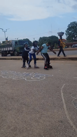 Young people roller skating and skateboarding in Jos streets
