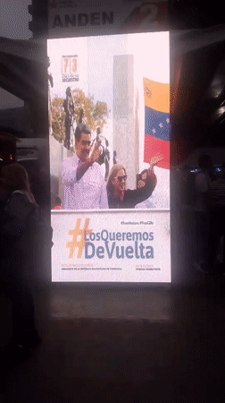 Evening scenes at Caracas bus terminal feature political displays