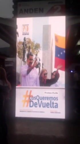 Evening scenes at Caracas bus terminal feature political displays