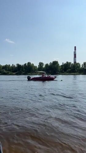Beach day on the Volga: sand, shallow water, and a camo boat
