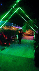 Nighttime documentation of neon-lit cafe district walkway
