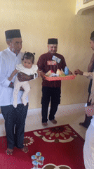 Traditional ceremony with baby, coconut, and offerings in Mandaong