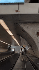 Woman navigates subway station levels in Sarıyer, Turkey