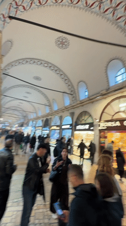 Tourist documents rainy day at Istanbul's Grand Bazaar