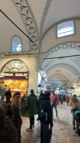 Tourist documents rainy day at Istanbul's Grand Bazaar