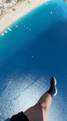Paraglider soars over turquoise waters near Fethiye, Turkey