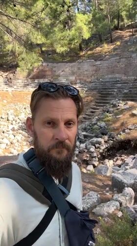 Ancient amphitheater in Fethiye, overgrown but intact