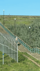 Man climbs staircase in sunny Chaikovsky, Russia