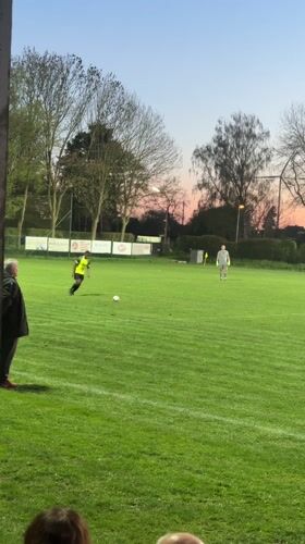 Evening gathering at Wegberg sports field during sunset