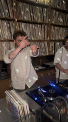 Two DJs perform in record-lined room in London