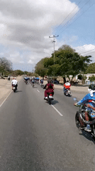 Cycling group travels road near San Juan Bautista, Venezuela