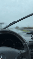 Woman drives through rain in Burgas, Bulgaria