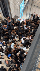 Large crowds queue at Belgrade shopping mall near Swatch store
