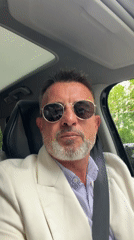 Well-dressed man observed in car driver's seat in Milan